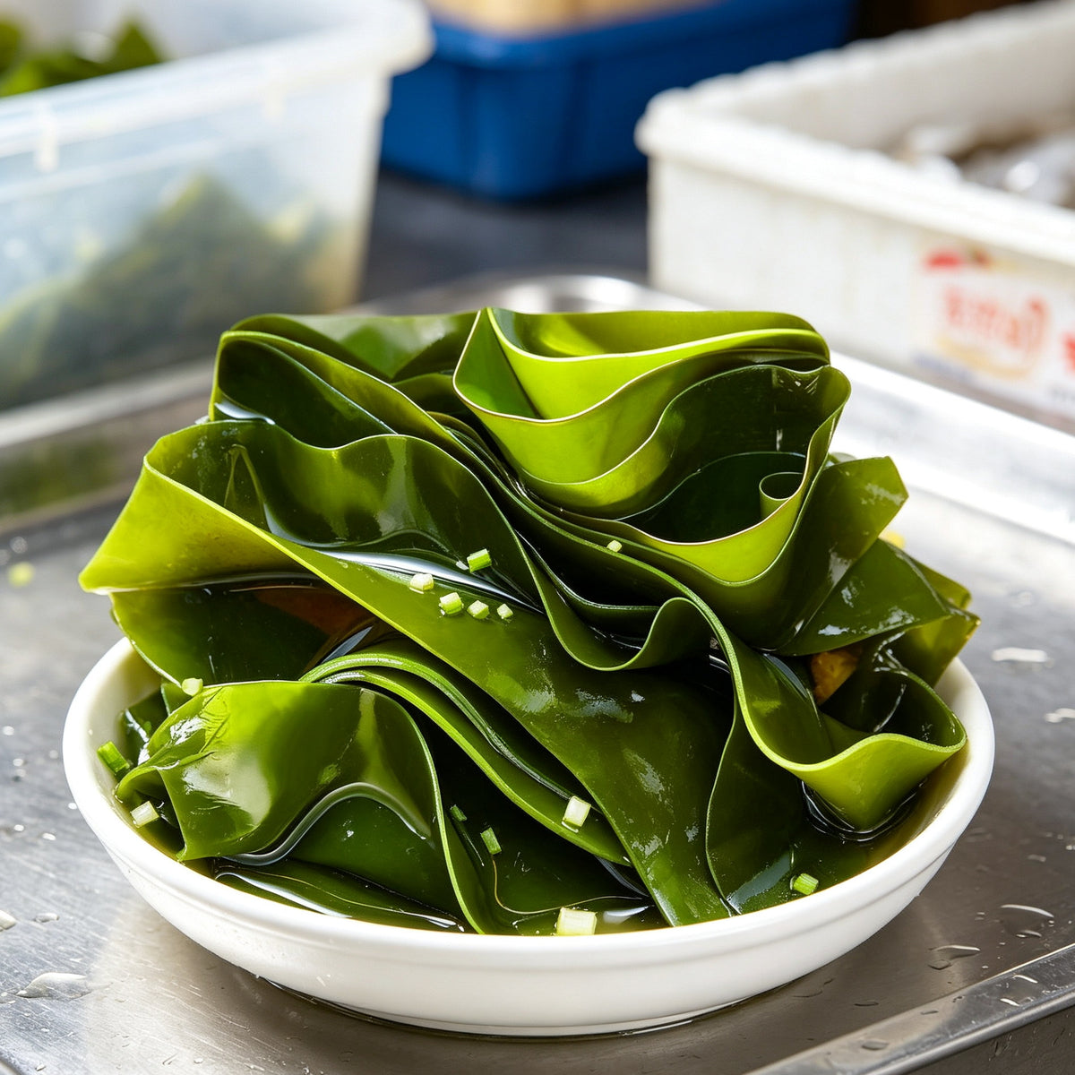 Green kelp sheets served in a shallow white bowl