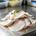Thin white snakehead fillets with dark mottled skin